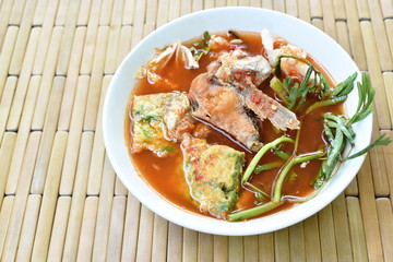 fried fish and egg stuffed climbing wattle in spicy sour soup on bowl