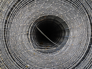 Metal mesh, twisted in rolls. Iron mesh for fence installation. Top view of the twisted lattice