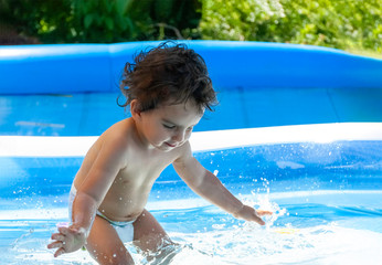 Little child playing in pool
