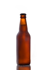 Bottle of white belgian beer over white background with reflection