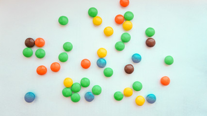 colorful chocolate buttons on a white background