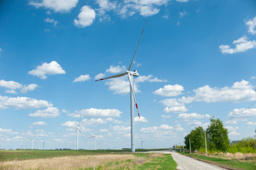Fototapeta na wymiar View on alternative energy windmills in a windpark in Ulyanovsk in front of a blue sky