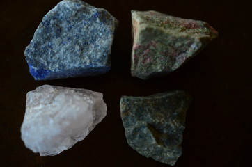 Set of 4 Raw Crystal Bundle. Natural Rough Crystals Kit: Unakite, Lapis Lazuli, Ocean Jasper, Rose Quartz. Crystal Variety Bundle Set. Low exposure natural light macro photography. 