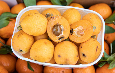 Ripe loquat or Eriobotrya japonica fruits in the greek vegetable fruit shop in May.