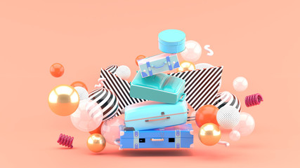 Travel bag overlaps among the colorful balls on the pink background.-3d rendering.