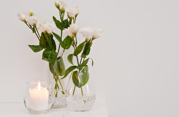 White eustoma flowers in glass on white background