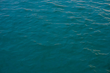 Fototapeta na wymiar beautiful texture of sea water with shallow wave, top view. thick blue-turquoise color.