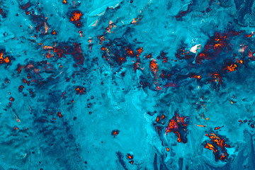 Blue fluid liquid surface with red sparkles on. Abstract acrylic oil paint texture. Flame sparks...