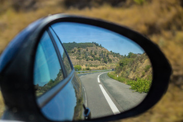 vision reflected in the rearview mirror of a car
