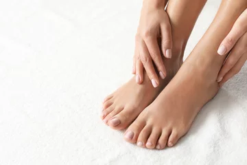 Abwaschbare Fototapete Pediküre Frau mit schönen Füßen auf weißem Tuch, Nahaufnahme. Spa-Behandlung