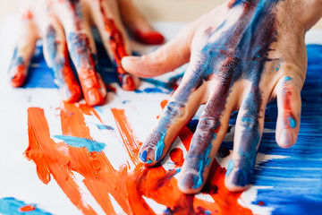 Art therapy. Hobby enjoyment. Man hands in red blue paint. Recreation relaxation. Artist talent...
