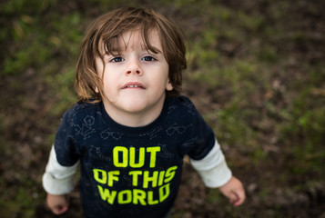 portrait of a little boy looking up at camera