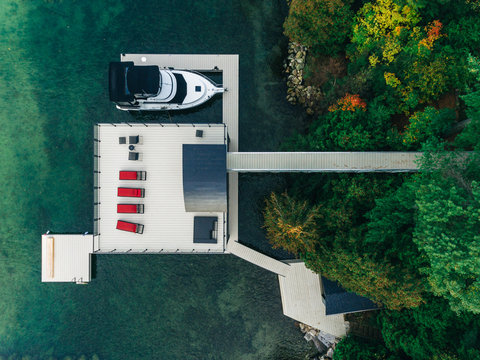 Overhead drone image of a boathouse on a lake