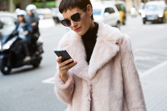 Stylish short haired business woman commuting between meetings on a busy city