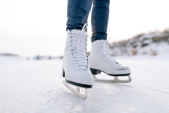 Crop woman skating on rink