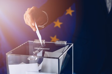 EU elections. Man throwing his vote into the ballot box.