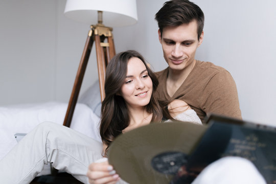 Happy young couple exporing music disks