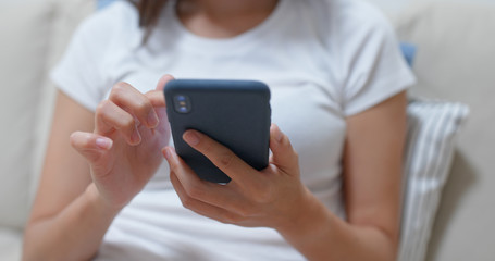 Close up of woman use of mobile phone at home
