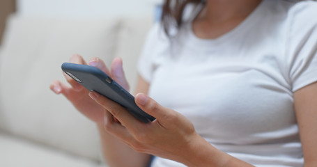 Close up of woman use of smart phone at home