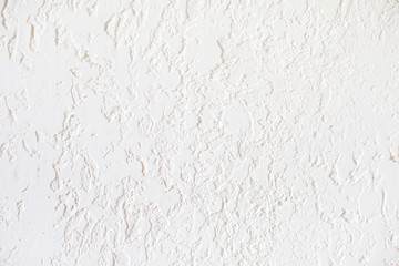 Smooth surface covered with textured plaster. Suitable for painting