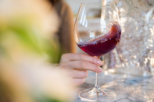 Woman swirling a glass of red wine
