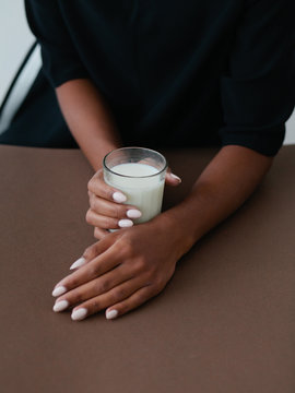 Glass with milk in woman`s hands