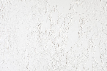 Smooth surface covered with textured plaster. Suitable for painting