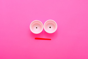 Disappointing ecological reality. Plastic garbage monster face on pink background. Zero waste lifestyle. Copy space.