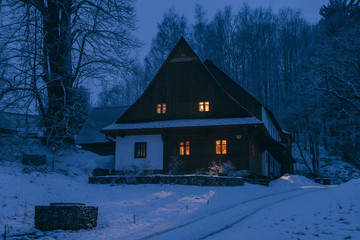 Traditional log cabin in snow covered landscape