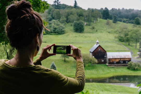 Woman Taking Landscape Photos on her Smartphone