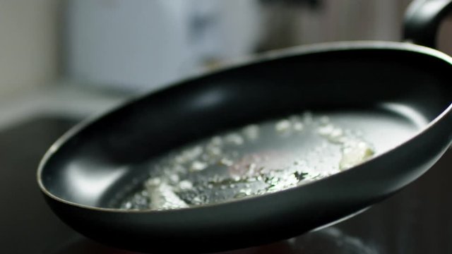 pan prepared by woman to cook scrumbled eggs