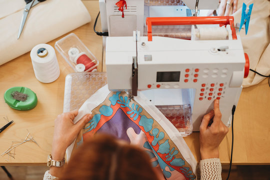 Young female designer using a sewing machine