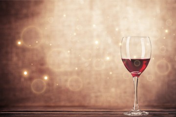Red wine glass on wooden desk