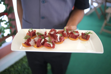 Waiter serving small portion food appetizer 