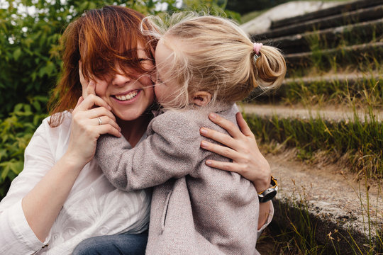 Little girl embracing her mom
