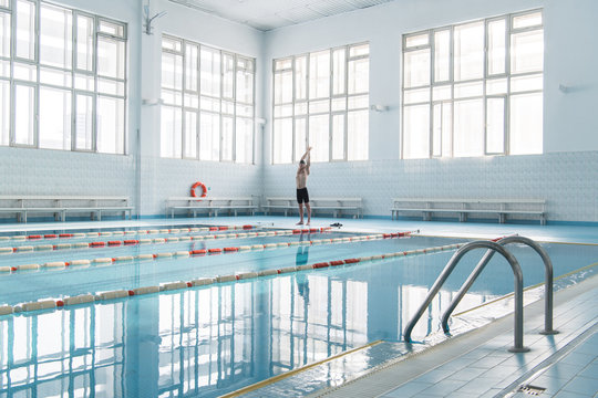 Swimmer standing in tranquil pool
