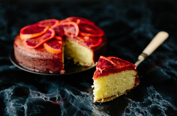 Sliced red orange cake glazed with orange syrup