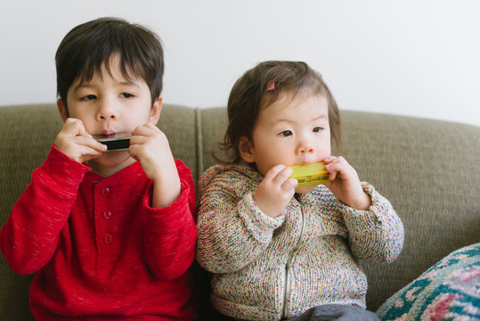 Little kids playing harmonica
