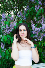 Portrait of a young beautiful brunette woman on a lilac background