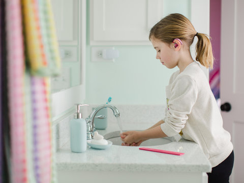 Young girl washing hands
