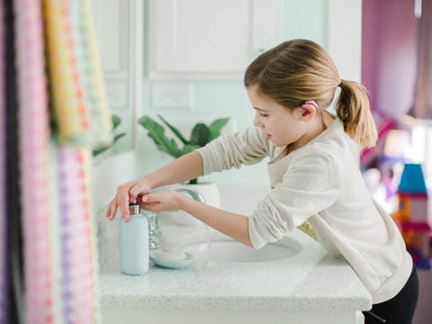 Young girl washing hands