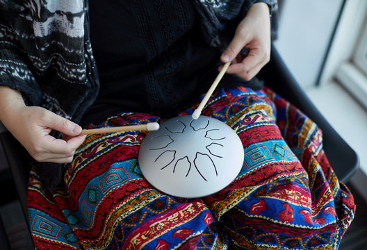 Asian women pounding instruments - 'empty drums' ,in airport, On the journey