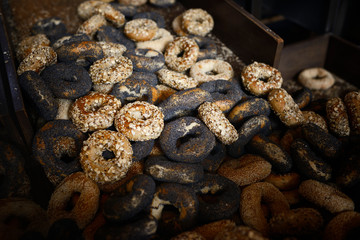 Pile of assorted bagels fresh out of the oven in a bakery