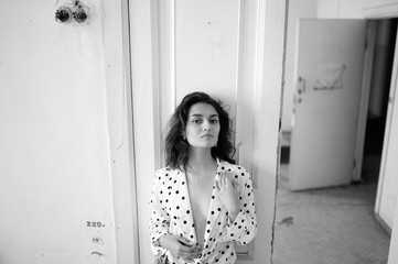 Young woman in a blouse in an abandoned room