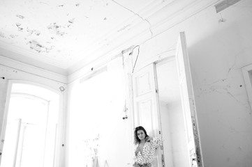 Young woman in a blouse in an abandoned room