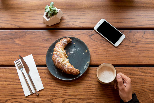 Croissant with cutlery in cafe