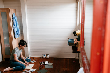 woman enjoying her free time at home doing paper handcrafts