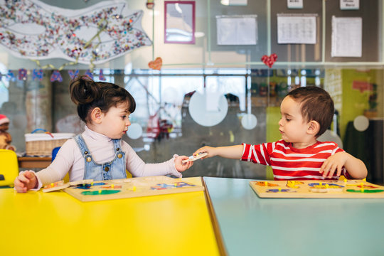 Little kid playing in kindergarten