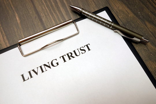 Clipboard With Living Trust And Pen On Desk