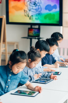 Students learning with digital tablets